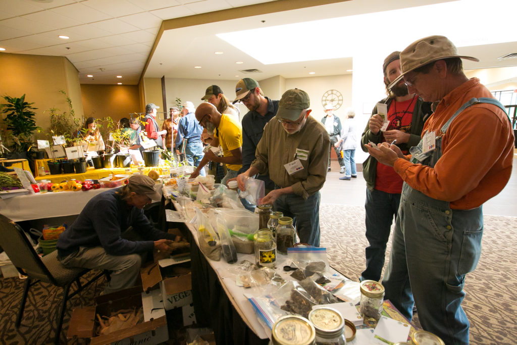 SAC attendees gathered around the seed swap table