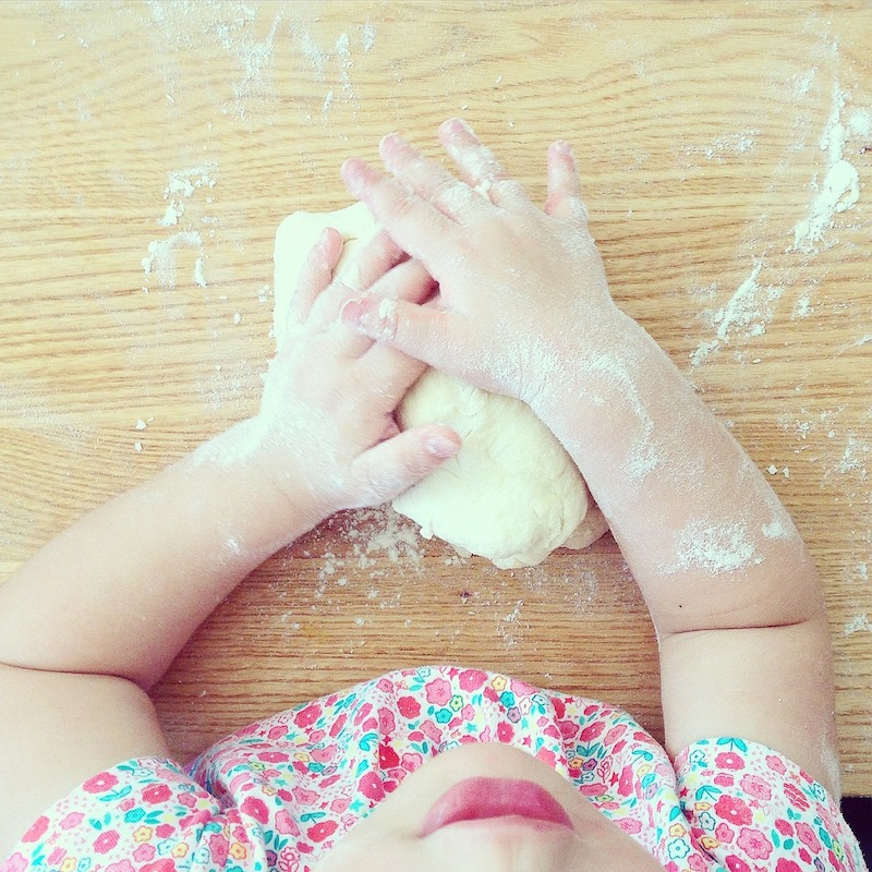 child with pizza dough