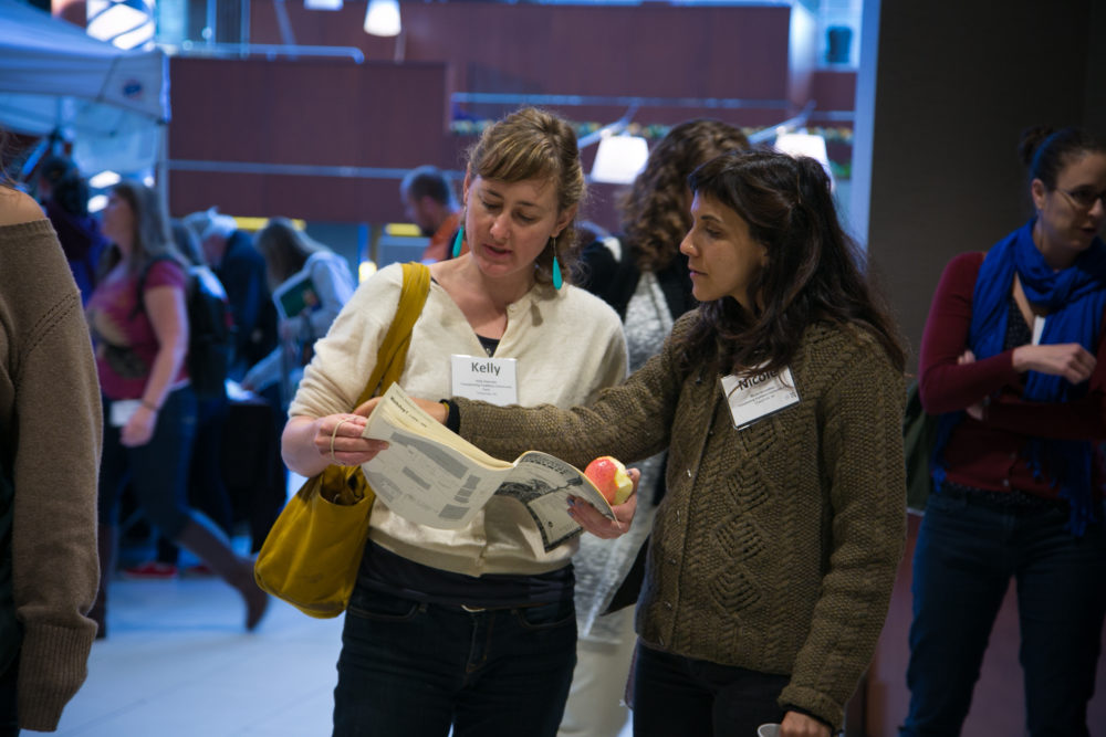 Two women looking at the conference program
