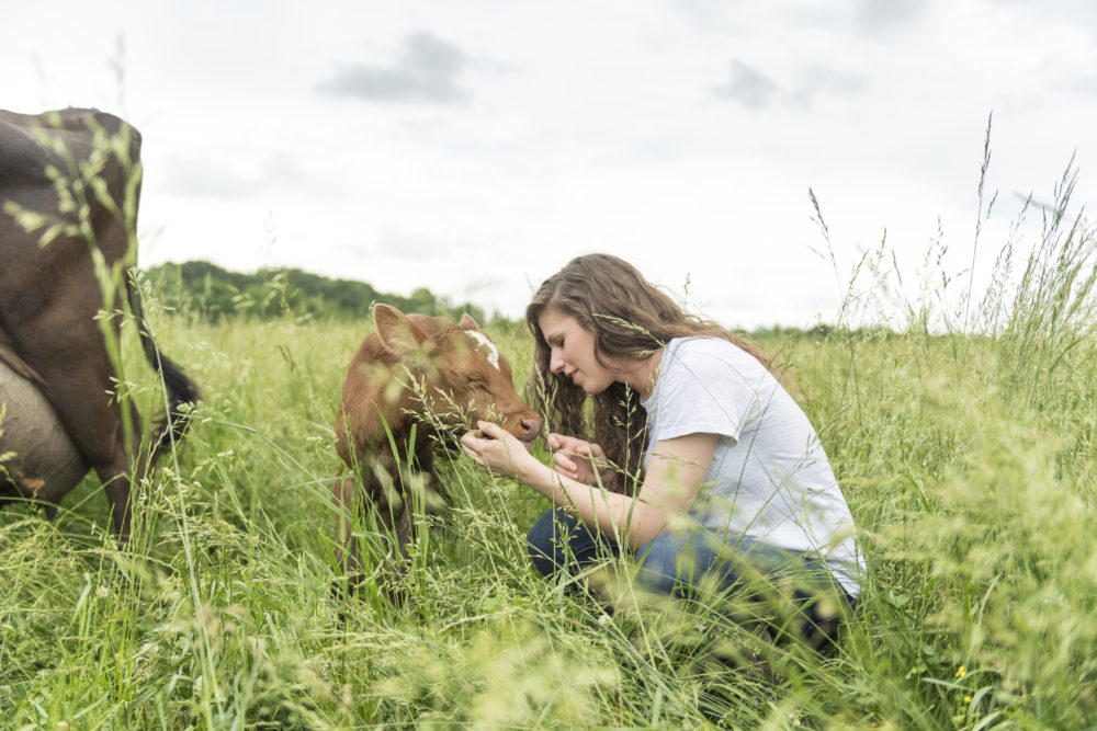 Farmer taking a moment with a calf at Lindale Organic Dairy. Credit: Organic Valley