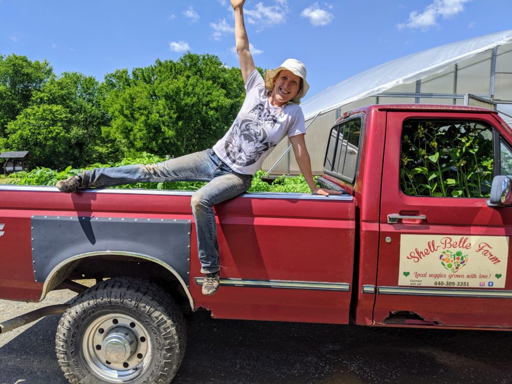Shelly Stamper, Shell-Belle Farm posing on a truck at Lomax Farm